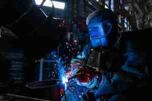 construction worker using a soldering iron to join metal and safely perform a construction project using tips from atlantic equipment