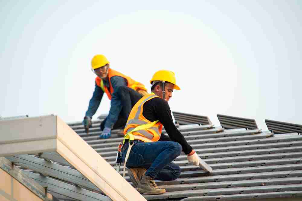 two cosntruction workers on roof using fall protection kit harnessews used equipment from atlantic