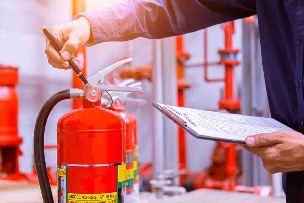 testing a fire extinguisher to put on a cosntruction site to use in case of a fire emergency