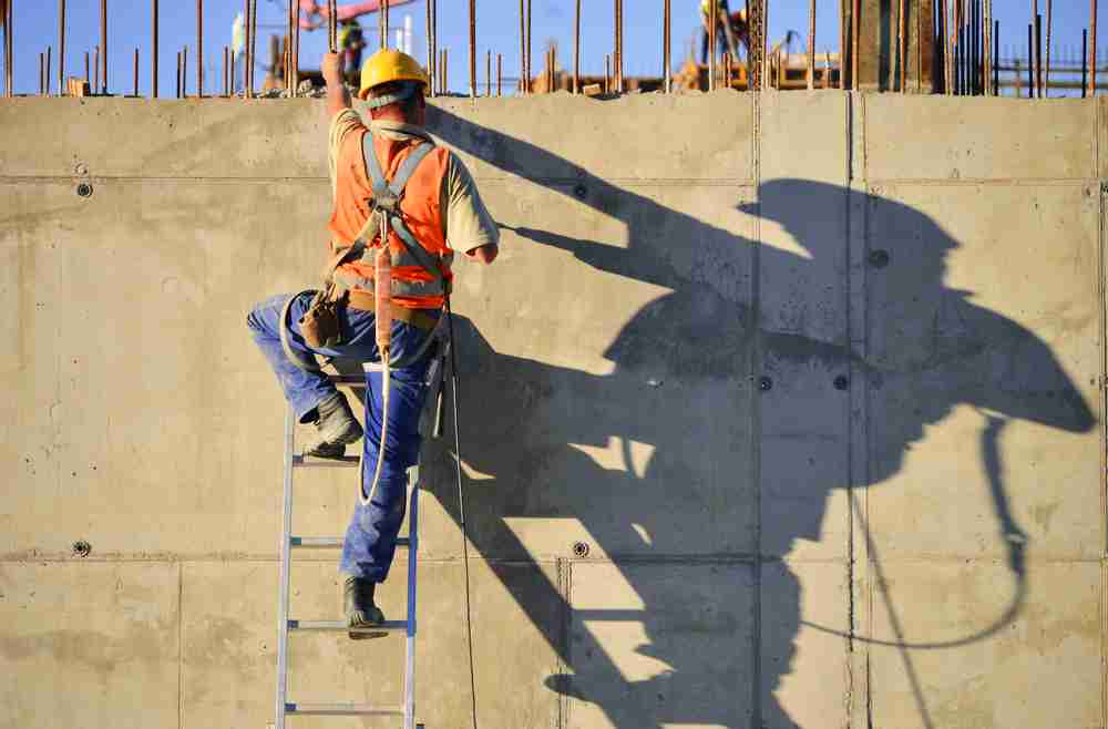 construction worker using ladder according to osha standards with safety and height requirements