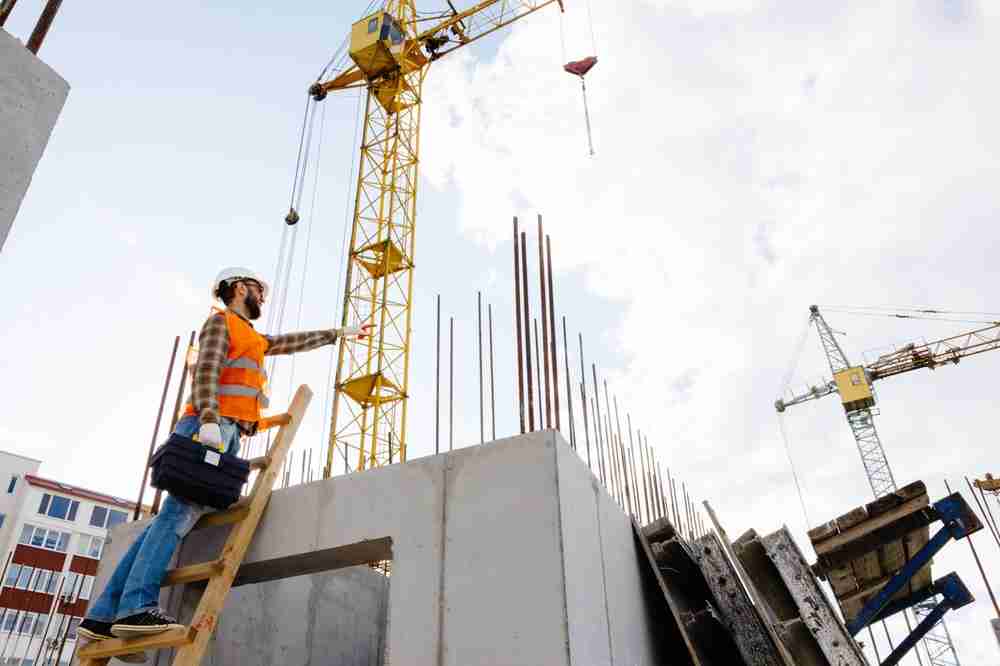 standing on a ladder extended to reach roof construction safely using osha standards and regulations and safety rail systems on the roof