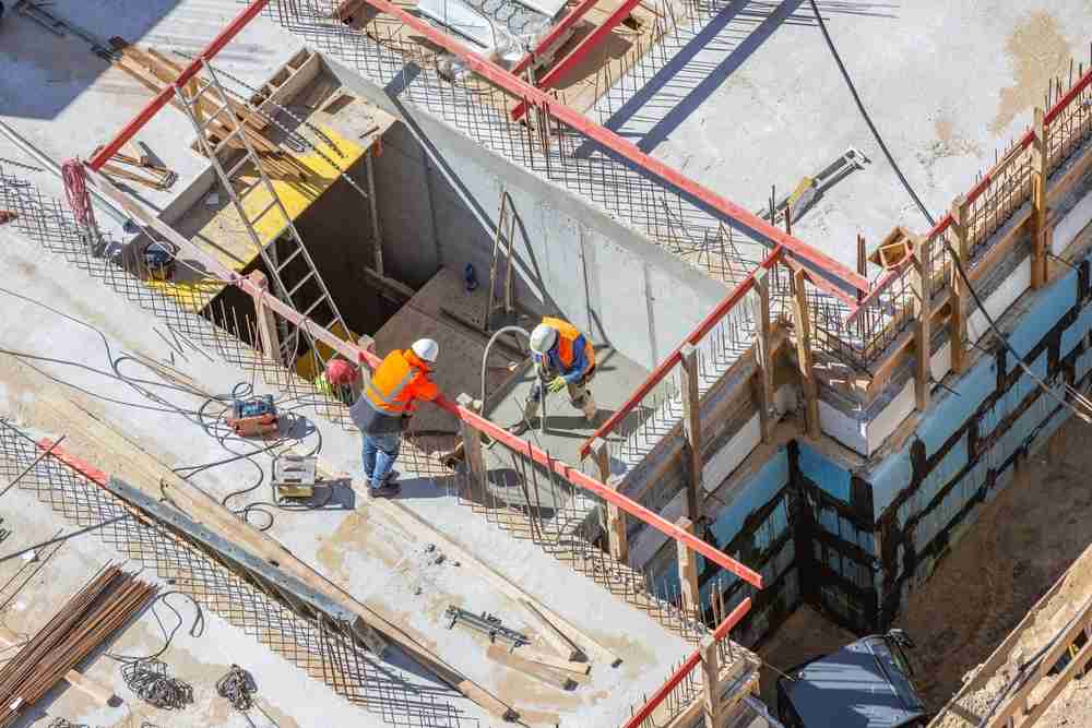 construction workers on a roof using ladders and fall protection equipment safety rail systems