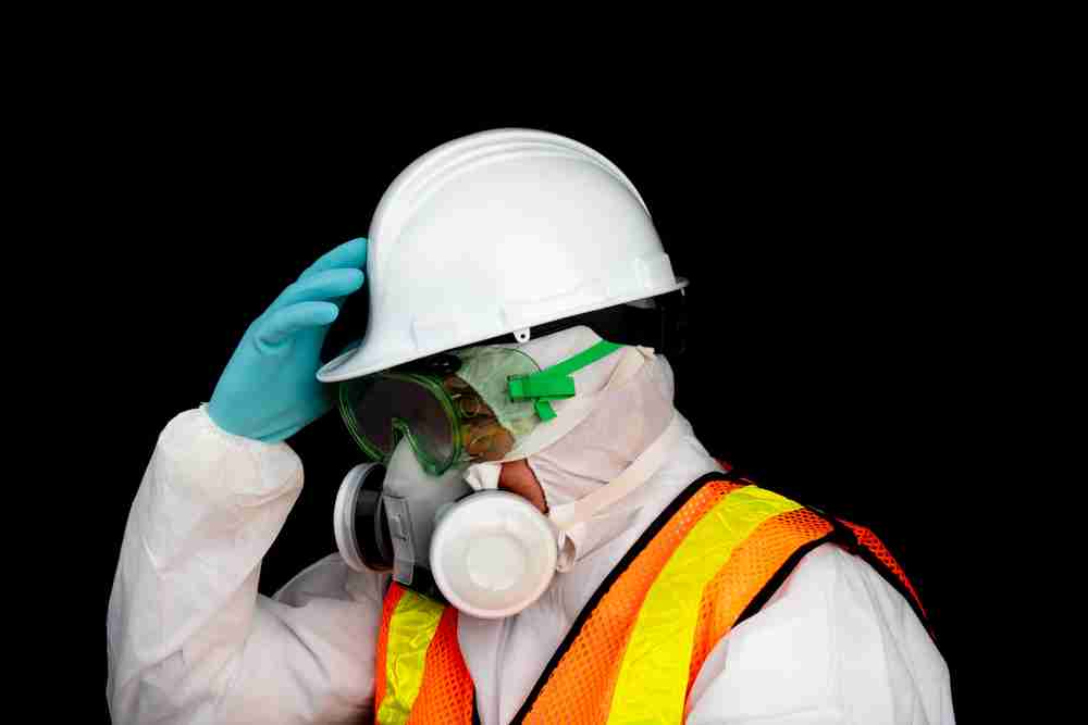 construction worker using a respirator mask to protect against dust on a construction site