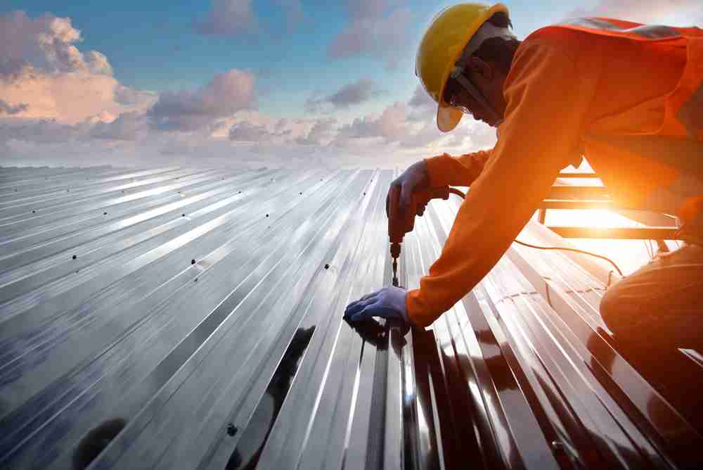 construction roofing worker working on roof during summer heat temperatures