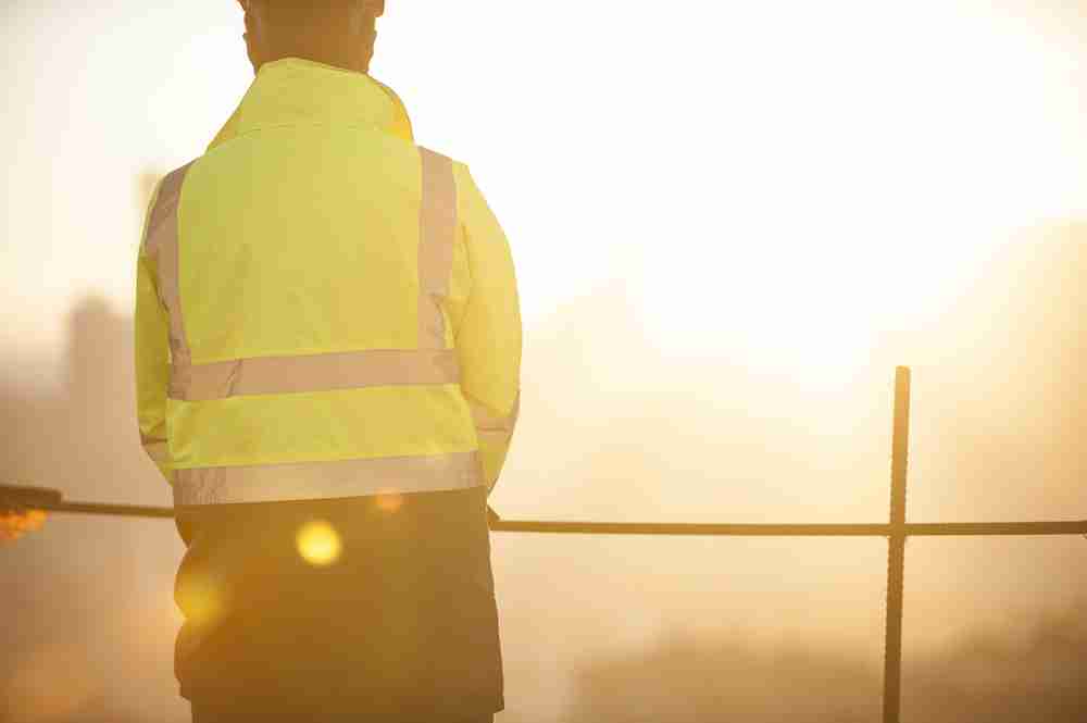 construction worker in sun in extreme heat working in the summer protected by osha rules and laws