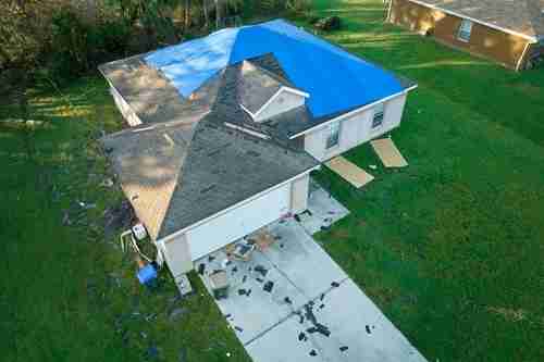 using a tarp to protect construction project equipment during a tropical storm hurricane