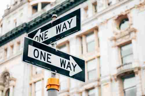 one-way street signs for a road where cars can only go one direction while construction is happening