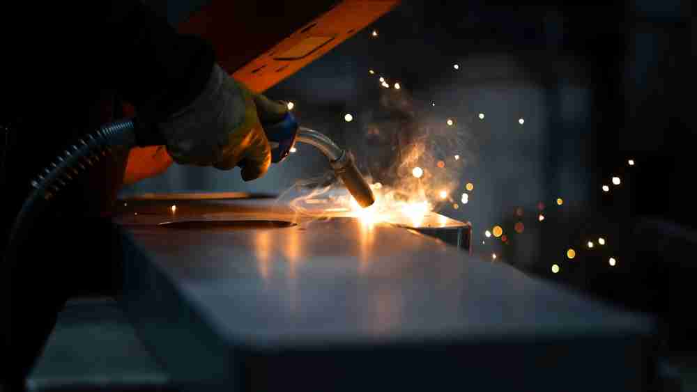 construction worker using leister welding equipment for a commercial project