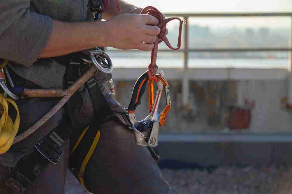 attaching a safety harness to scaffolding construction project with anchor